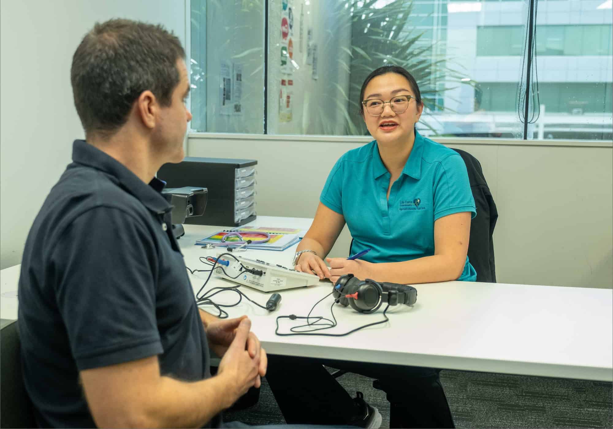 Life Care health professional discussing hearing test results with a client.