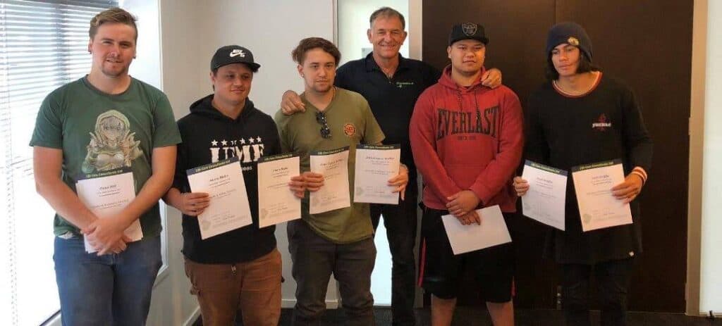 Group of men holding certificates after completing a Life Care training course.